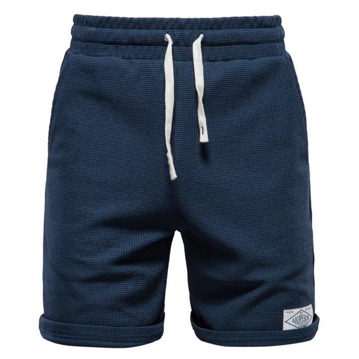 Novedad de verano, pantalones cortos de color liso, pantalones cortos deportivos y de ocio para hombre, pantalones cortos con lazo en la cintura elástica, ropa exterior de talla europea, pantalones de tres cuartos - 1