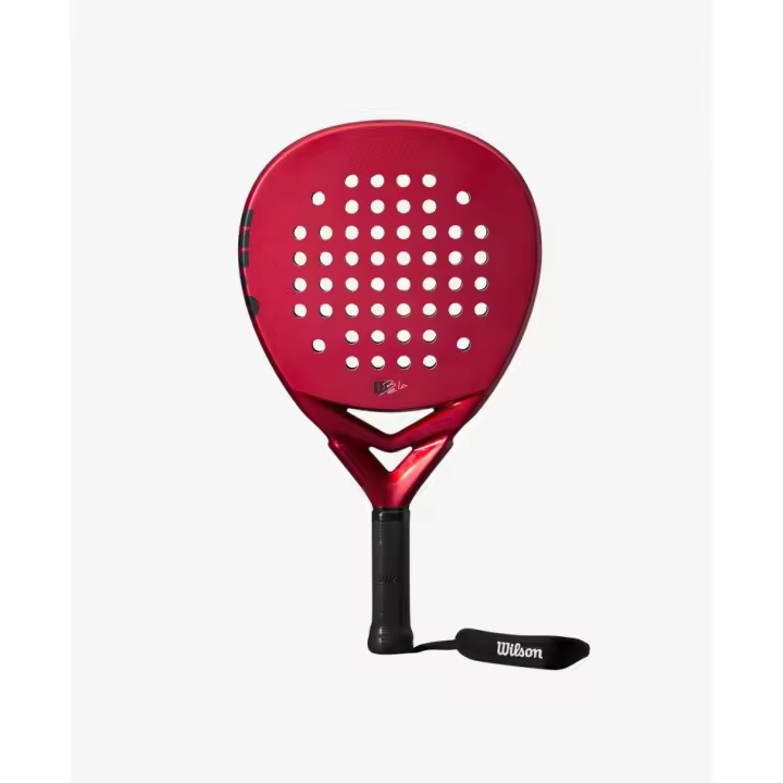 PALA WILSON BELA V2 JUNIOR, ha sido creada para las futuras promesas. El tejido de fibra de vidrio y el núcleo de espuma confieren a esta pala una estabilidad y un confort de primera calidad. - 1
