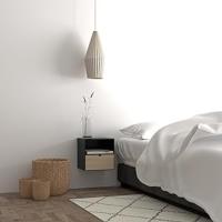 Bedroom environment showing a bed and a rectangular bedside table on the wall