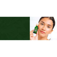 Young adult woman with clear skin holding Hyaluronic acid serum