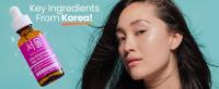 Korean skincare model standing next to Seoul Ceuticals Kojic Acid Serum for face
