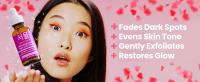 Korean skincare model holding the Kojic Acid Serum for hyperpigmentation