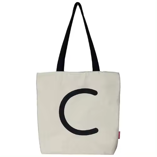 Bolso tote con cremallera, forro y bolsillo interior. Exterior: Algodón 100%. Incluye sobre de regalo de papel kraft. Modelo C. Color: Crudo / Negro. Medidas: 37x38 cm. - 1