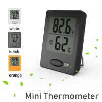 Termómetro de ambiente, mini medidor de humedad, termómetro higrómetro negro, blanco y naranja con pantalla LCD transparente e íconos de cara - details 0