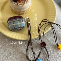 Retro marrón - cuello a cuadros azul - estuche para auriculares Bluetooth colgante. Es una funda protectora de silicona suave adecuada para Apple AirPods 4, AirPods Pro 1/2 y AirPods 3. - details 0
