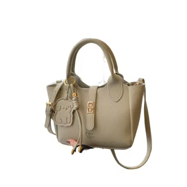 Bolso de mano elegante con forma de cubo cruzado inclinado, bolso de mano con colgante de cachorro para mujer, bolso de hombro de cuero de PU de alta gama con patrón de lichi, primavera y verano - 1