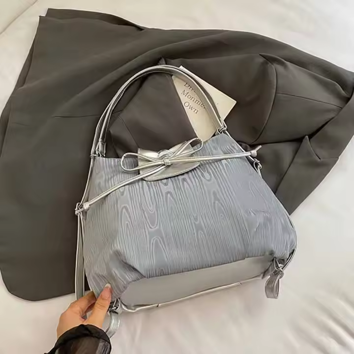 Mochila con lazo plateado de Color sólido, bolso de hombro versátil de estilo coreano, bolso de mano versátil de gran capacidad para niñas - 1