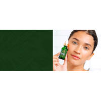 Young adult woman with clear skin holding Hyaluronic acid serum