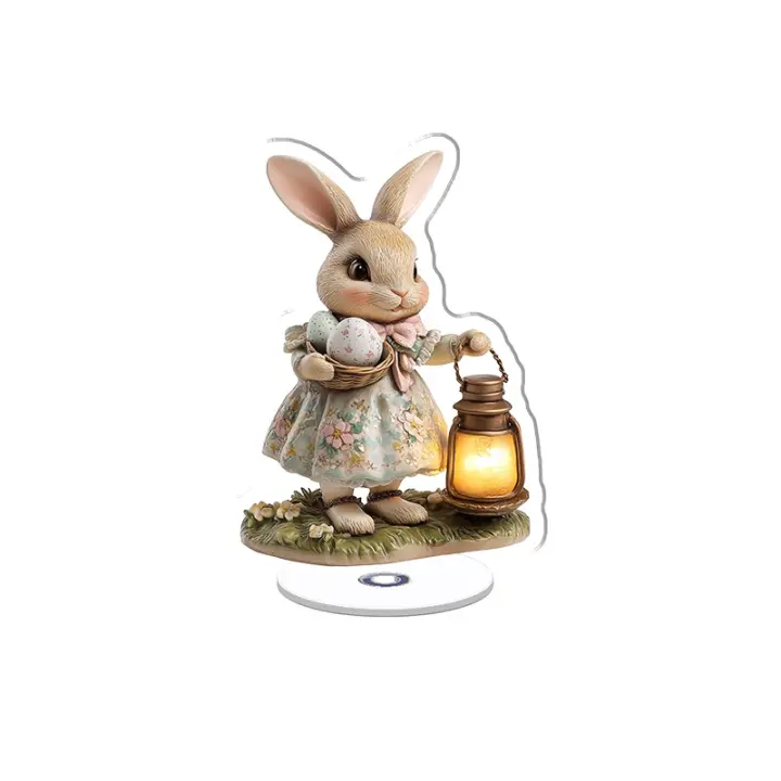 Una pantalla acrílica giratoria presenta un conejito de Pascua de cerámica brillante con huevos y una linterna, adornada con motivos florales y una expresión alegre. - 1