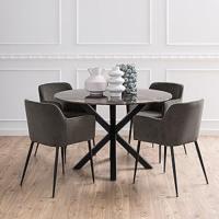 Dining room environment showing a round dining table with 4 chairs around it and some decor