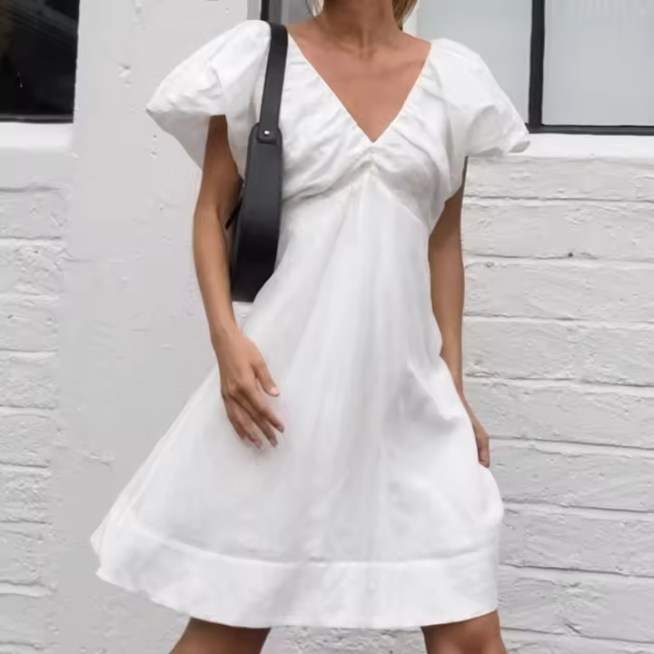 Vestido Xiaoxiangfeng de algodón y lino con cuello en V, manga abullonada y lazo, nuevo para otoño e invierno, versátil, de color blanco sólido. - 1