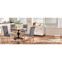 El texto dice «MAKE YOUR COMFORTABLE». Disposición de comedor con mesa redonda con pedestal y sillas con capitoné grises, aparador blanco y arte decorativo en la pared en un ambiente interior luminoso.