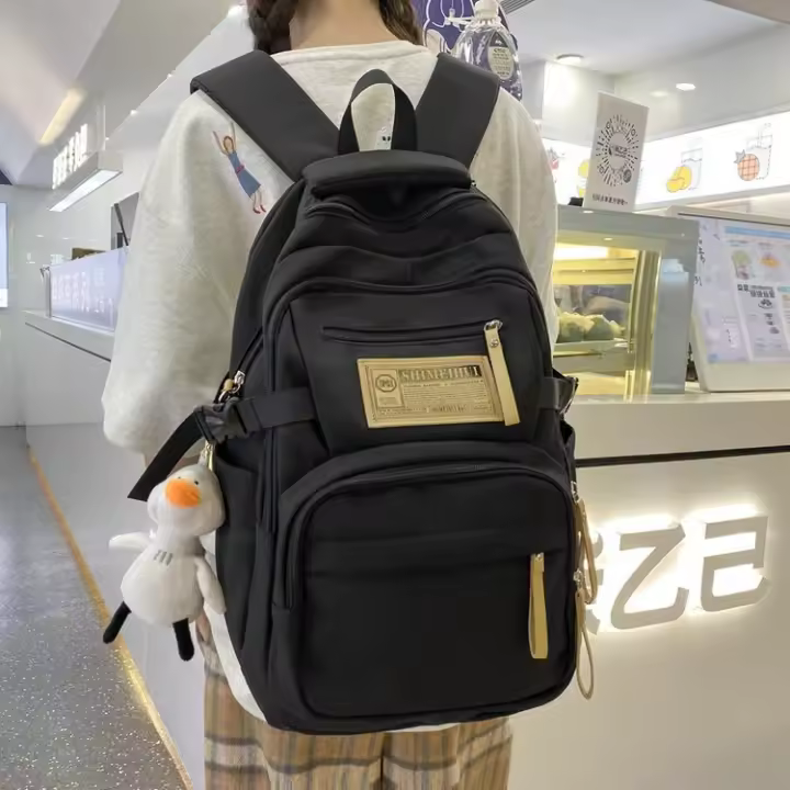 Mochila de Nylon de Gran Capacidad Ideal para Estudiantes Universitarios, de Secundaria, de Preparatoria Moda Callejera - 1