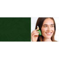 Young adult woman with clear skin holding Niacinamide serum